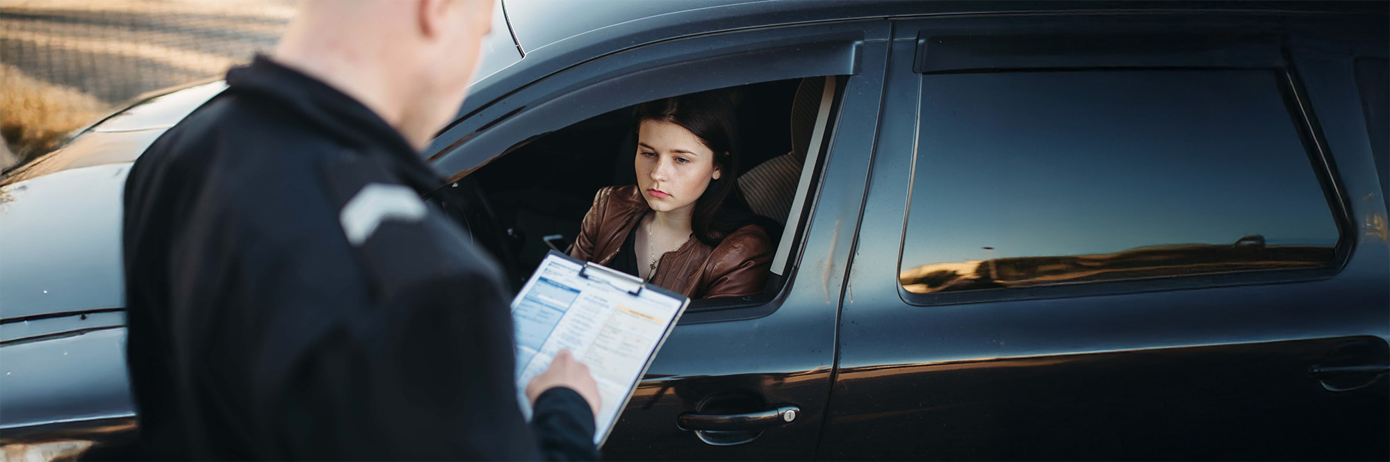 Policeman in uniform writes fine to female driver
