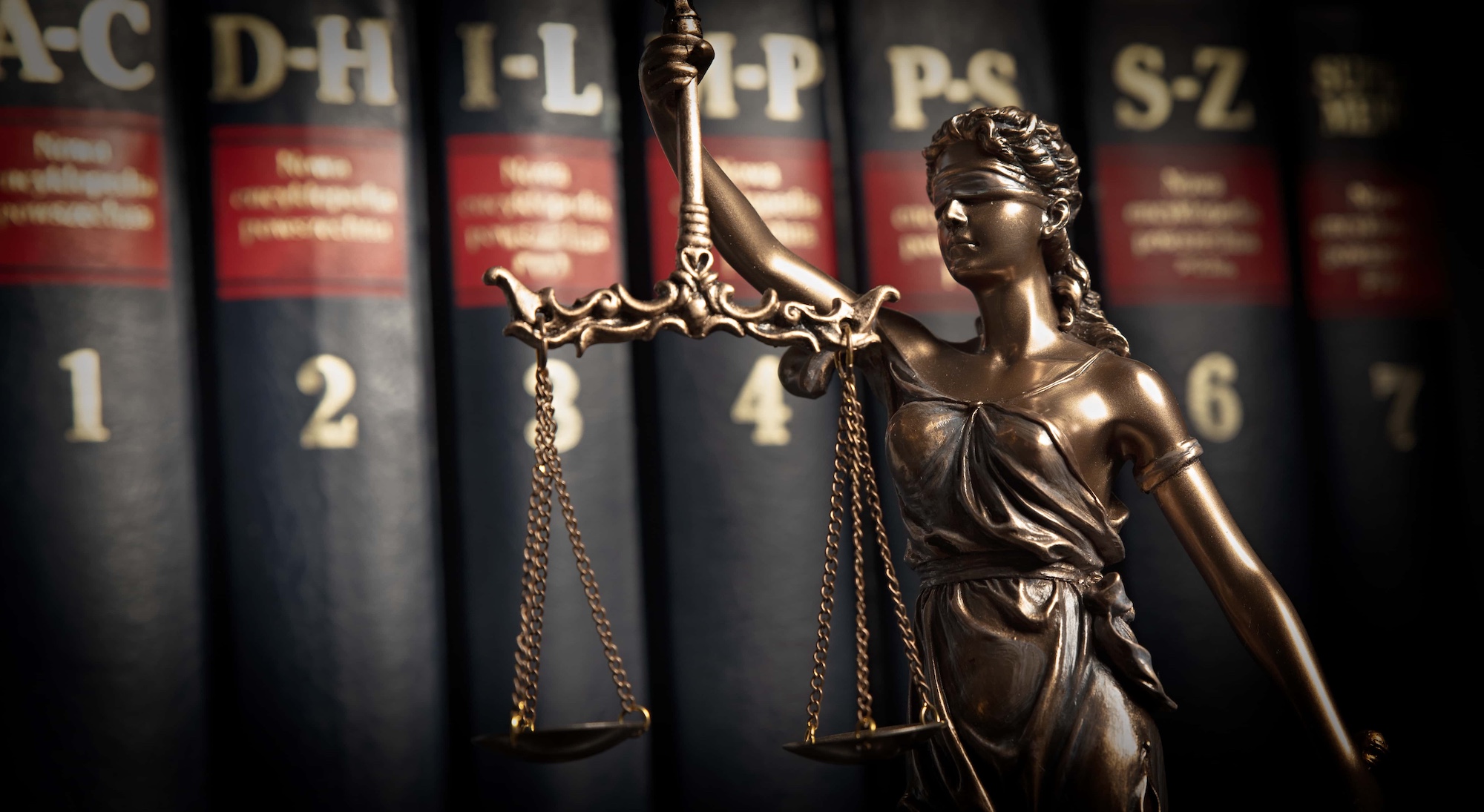 Statue of justice on books background 1