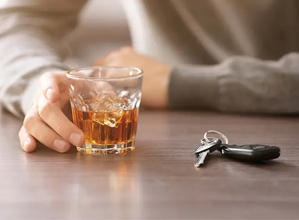 glass of whiskey sat next to car keys
