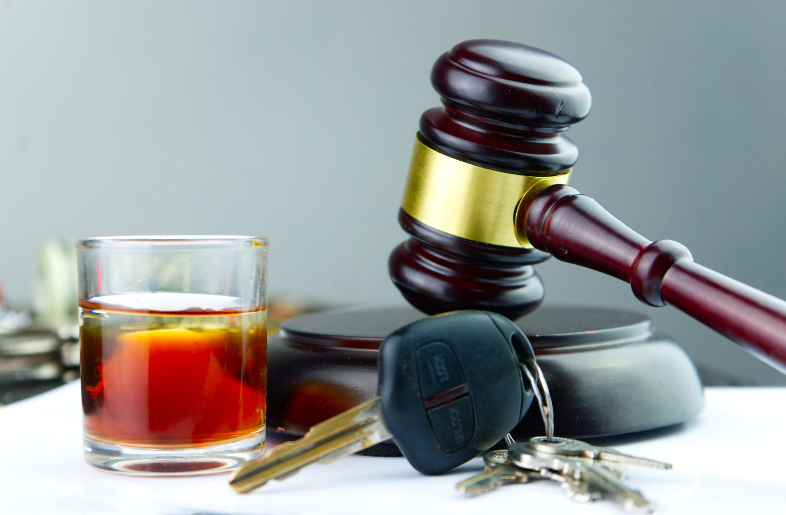 alcoholic beverage in glass gavel car keys drunk driving concept